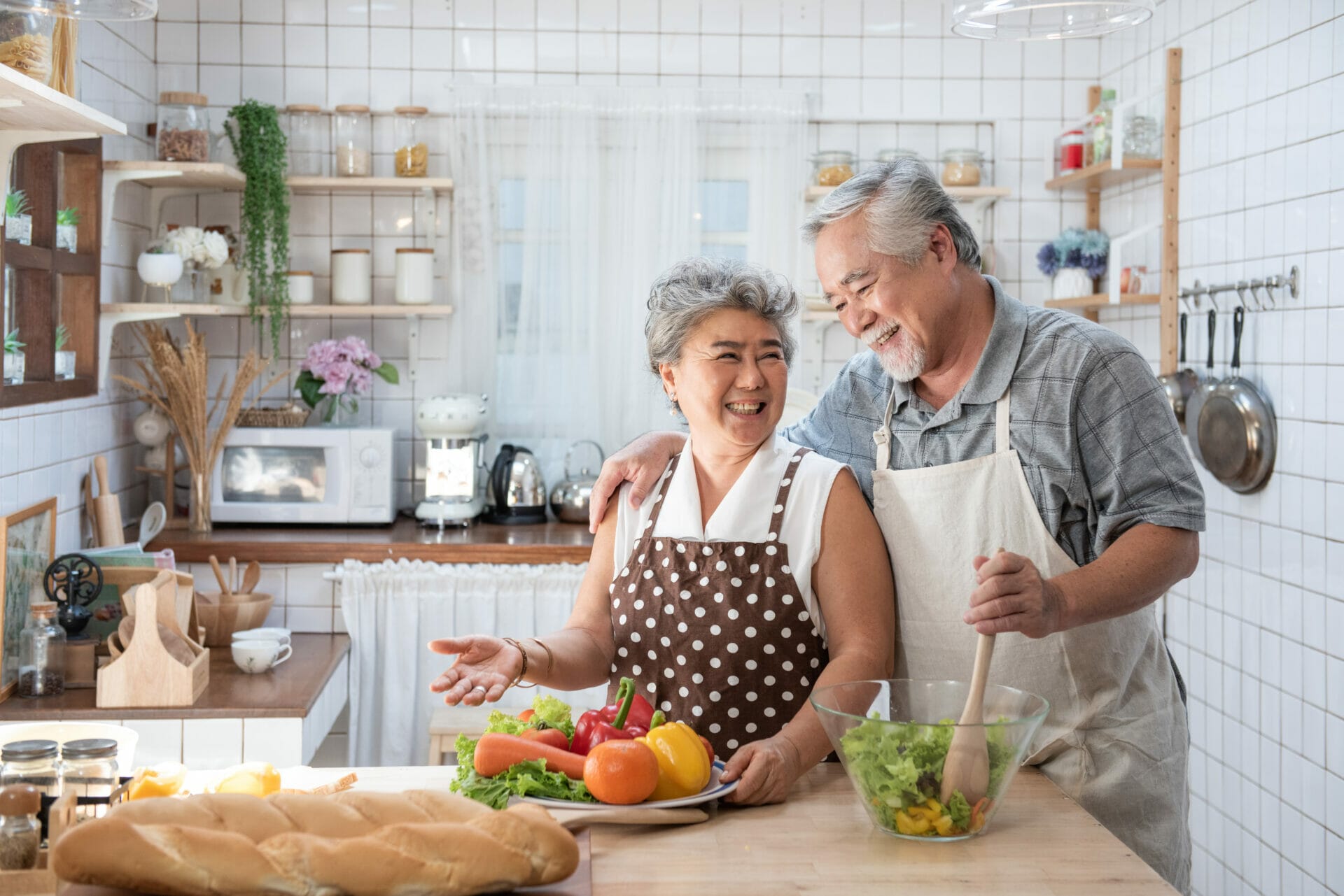 senior couple having fun kitchen with healthy food retired people cooking meal home with man woman preparing lunch with
