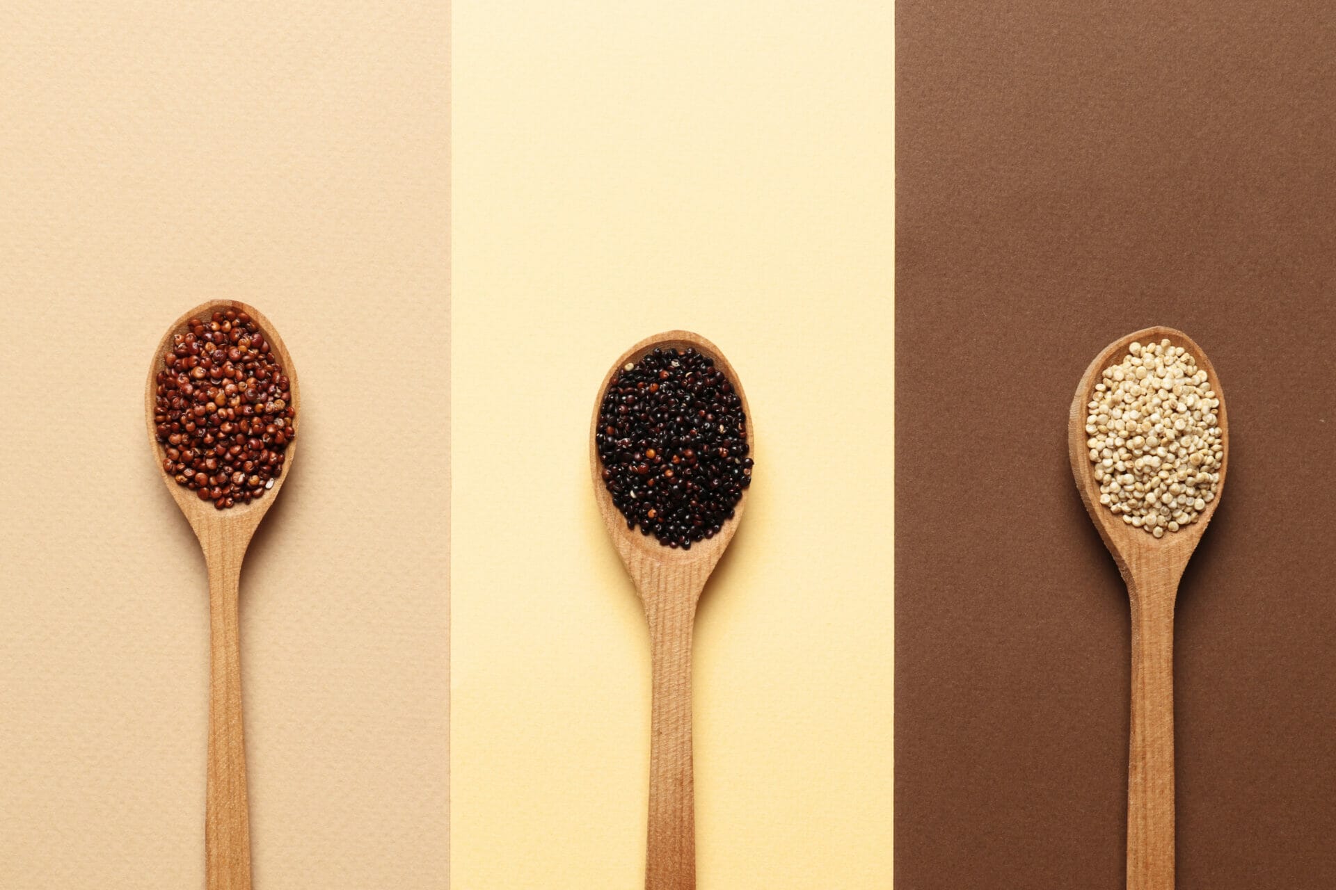composition quinoa all kinds wooden spoons background top view
