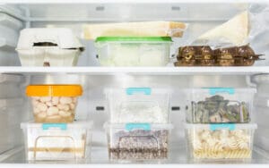 front view organized plastic food containers fridge