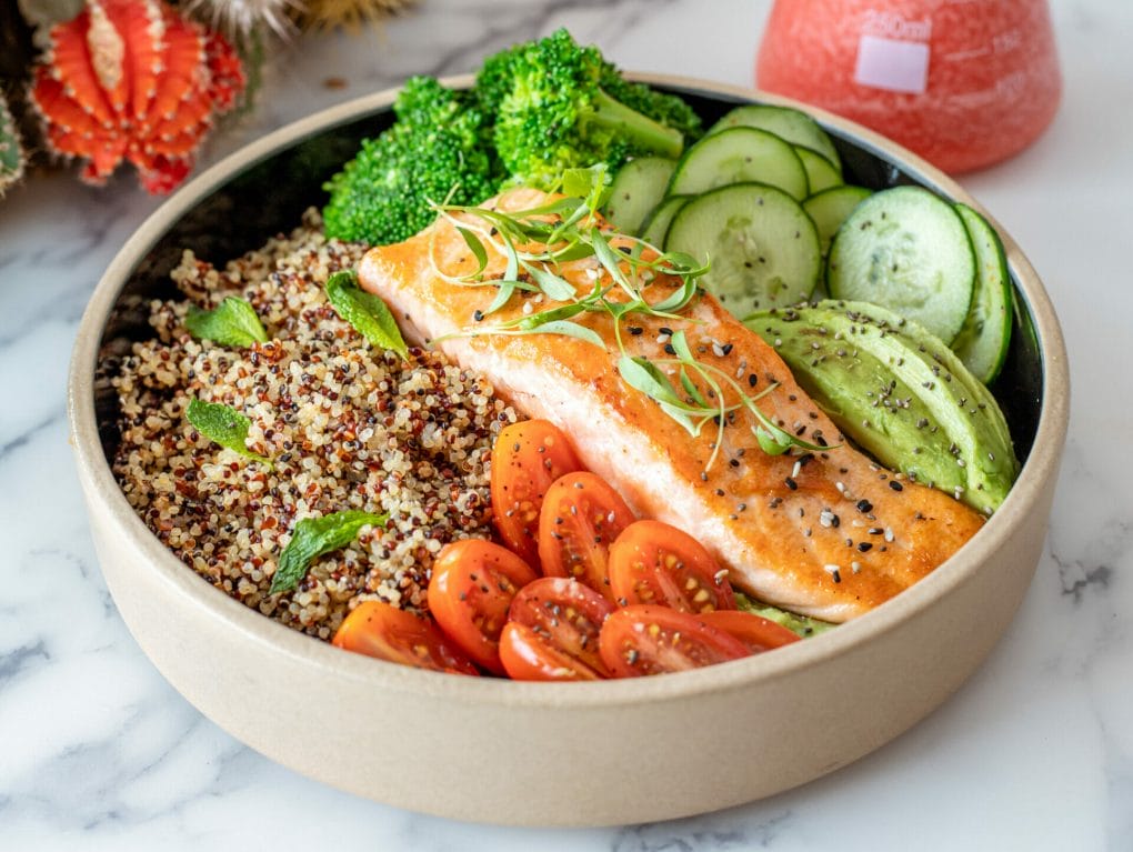 plate salmon with quinoa raw vegetables