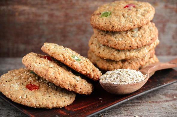 oatmeal cookies spoon with oat flakes wooden table